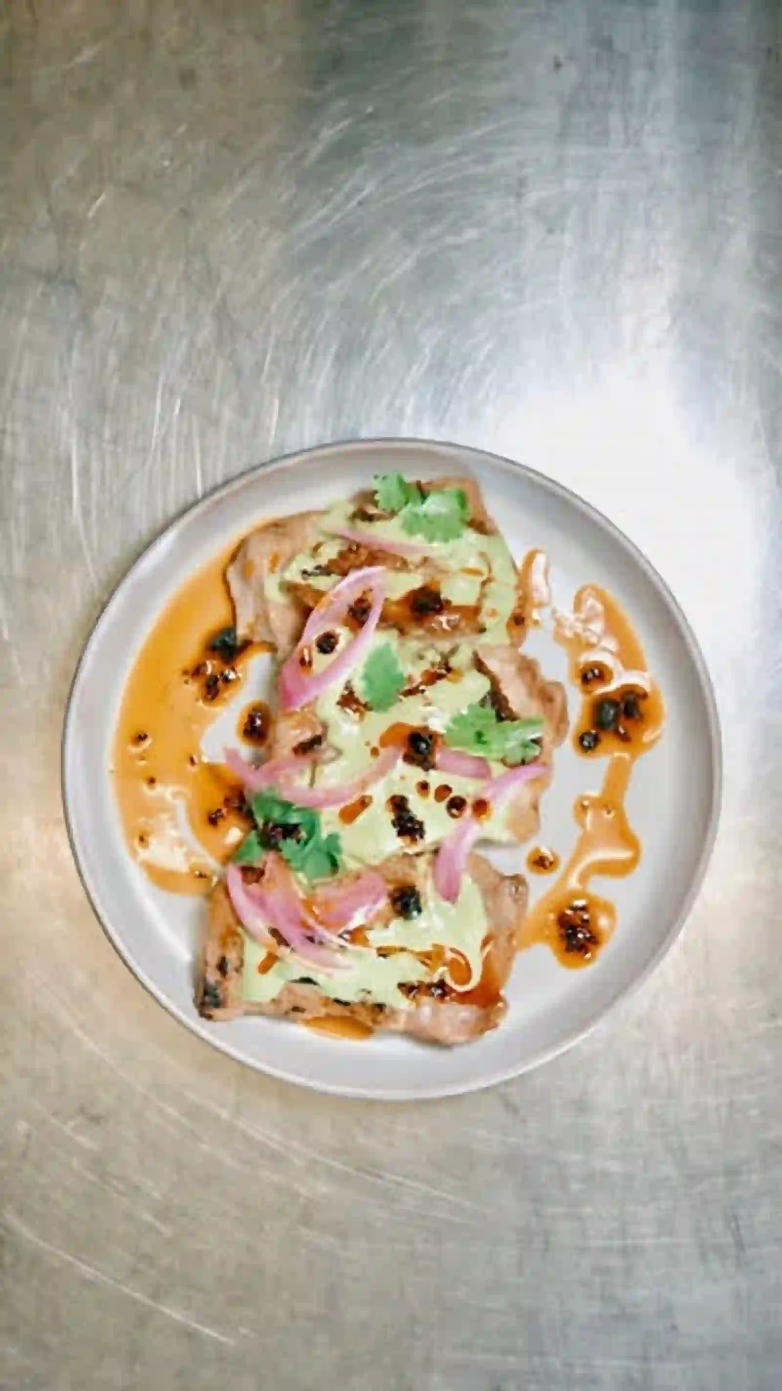 Plated small plate with chili oil and herbs